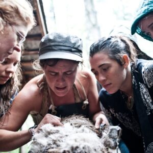 woman identifying membrane during hide tanning teaching