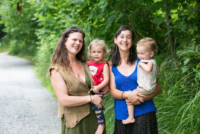 Chloe Lieberman and Natalie Bogwalker holding their children