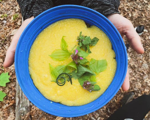 bowl of polenta topped with wild greens