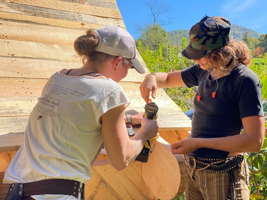 Two women work together during women's advanced carpentry class