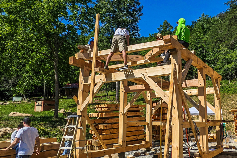 students building a mortise and tenon structure at a Wild Abundance Timber Framing Workshop