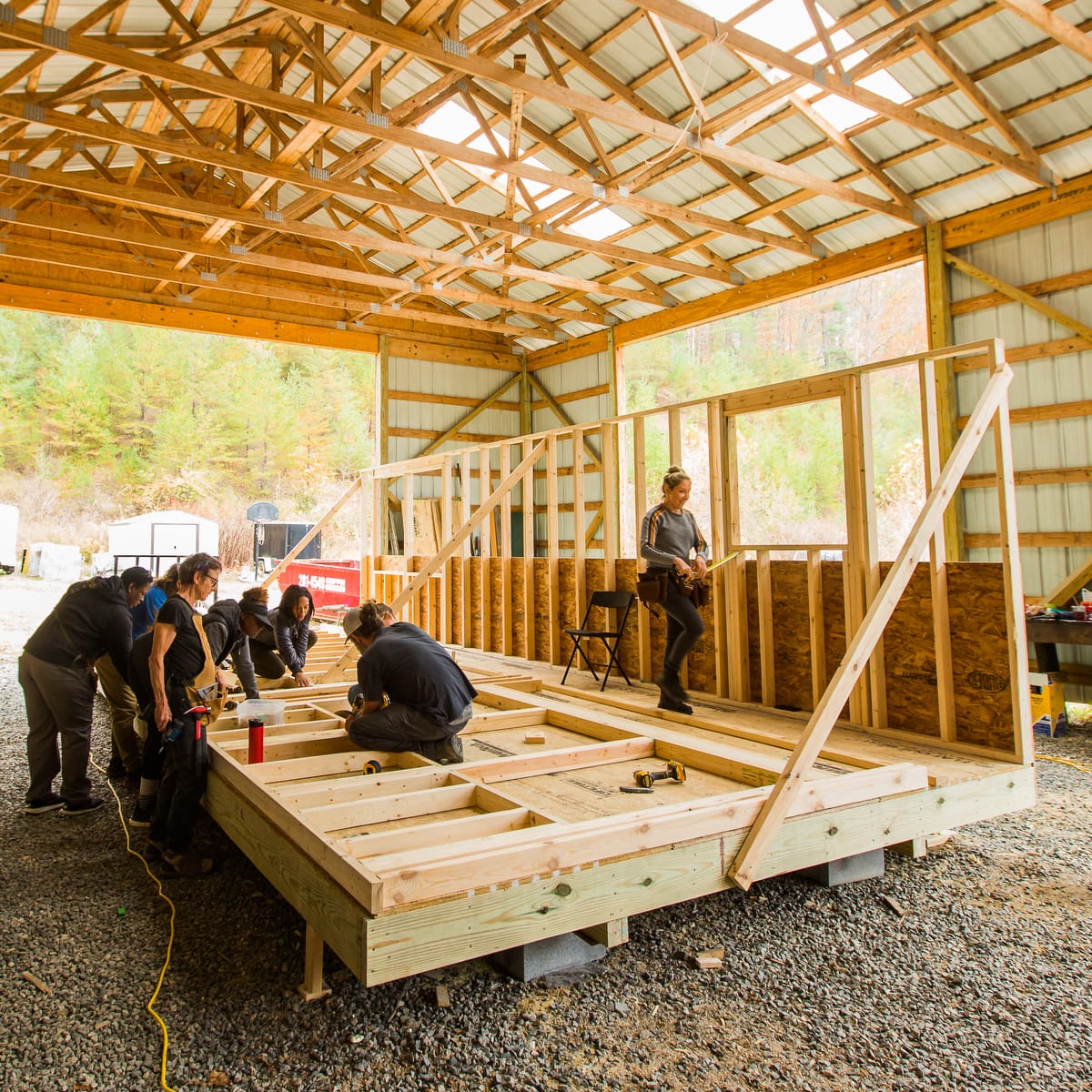 Students work on framing the 2nd wall for a Tiny House during the 10 day hands-on Tiny Home building workshop at Wild Abundance