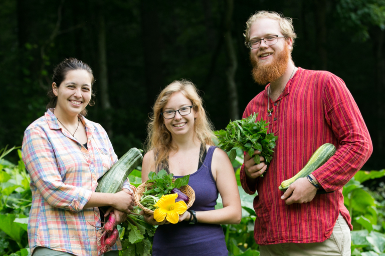 students holding vegetables they harvested at the 9 month Gardening and Permaculture Apprenticeship program at Wild Abundance