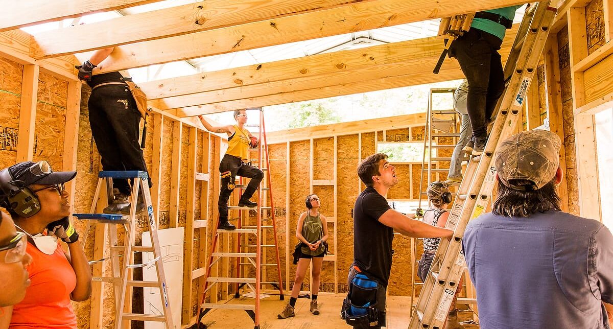 Students working as a team to construct a Tiny House in a 10 day building workshop at Wild Abundance