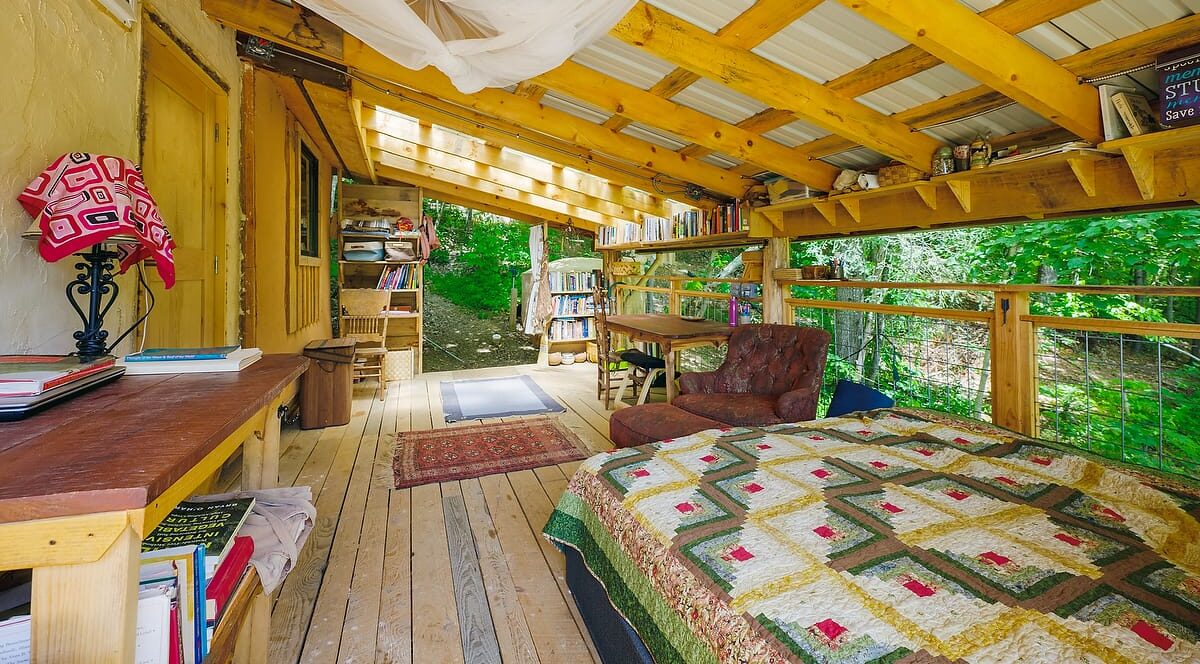 a few of the sleeping porch built off the side of a Tiny House at Wild Abundance, just one example of creative ways you can live with more freedom and space than you initially anticipate when considering a tiny home lifestyle.