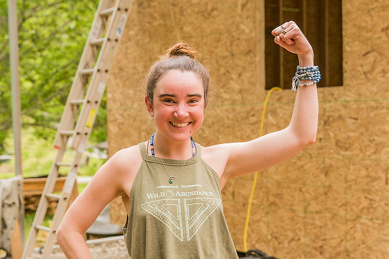 A student building a custom DIY tiny house by following plans and instructional videos in the Online Tiny House Academy from Wild Abundance